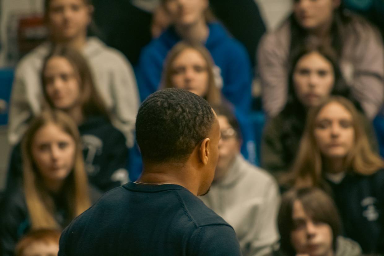 A speaker addressing a group of students